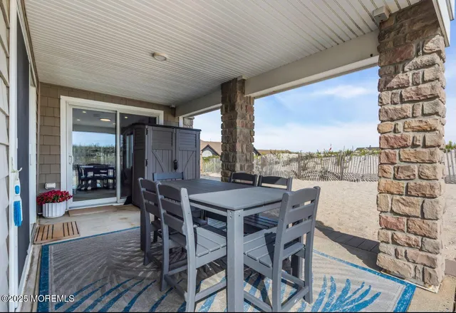 a view of a patio with a table chairs and a potted plant