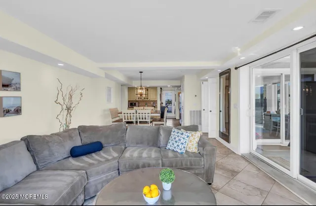 a living room with furniture and kitchen view