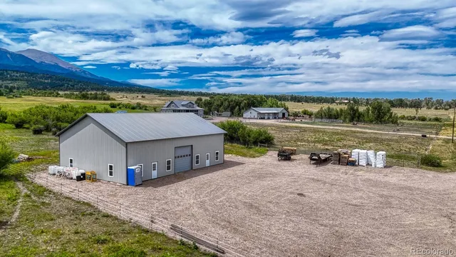 a view of a house with a yard and sitting area