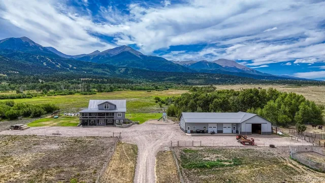 an aerial view of a house with garden space ocean and mountain view