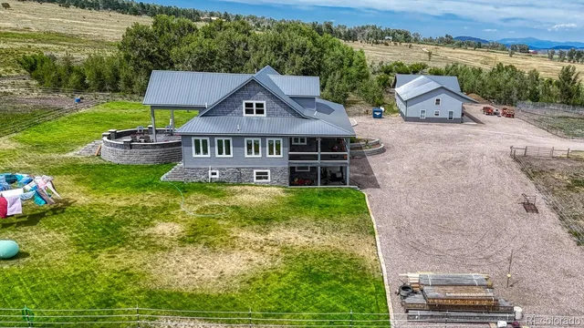 an aerial view of a house with garden space and street view