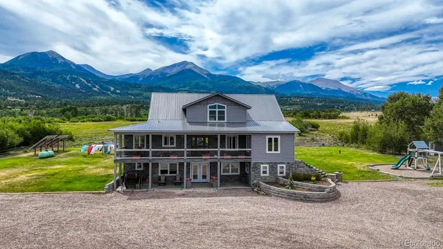 an aerial view of a house with a garden and yard