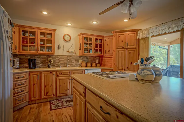a kitchen with stainless steel appliances granite countertop a sink stove and cabinets