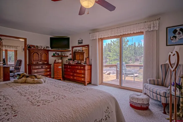 a bedroom with furniture and a flat screen tv