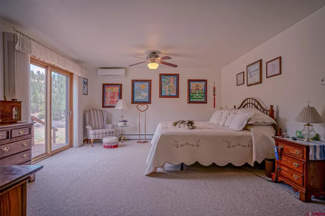 a bedroom with bed couch and window