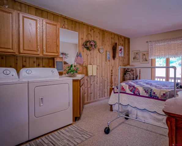 a view of a bedroom with washer and dryer