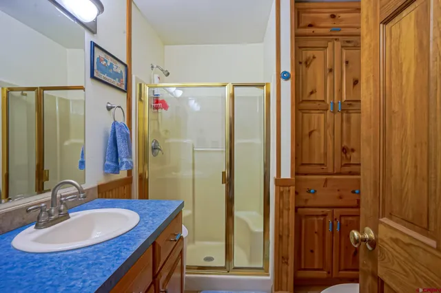 a bathroom with a sink double vanity granite tub shower and a mirror
