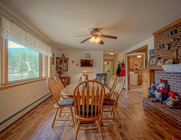 a view of a dining room with furniture window and wooden floor