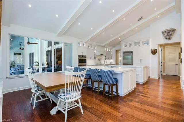 a dining room with furniture and wooden floor