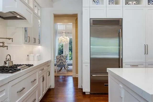 a kitchen with stainless steel appliances a refrigerator and a stove
