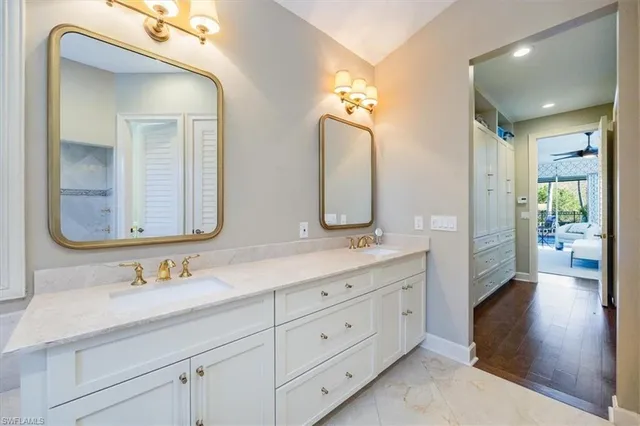 a bathroom with a double vanity sink and a mirror