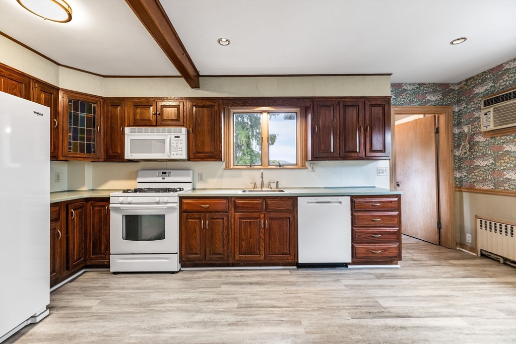 29 Undine Road Boston, MA 02135 - Photo 5 of 16 a kitchen with stainless steel appliances granite countertop a stove and a sink