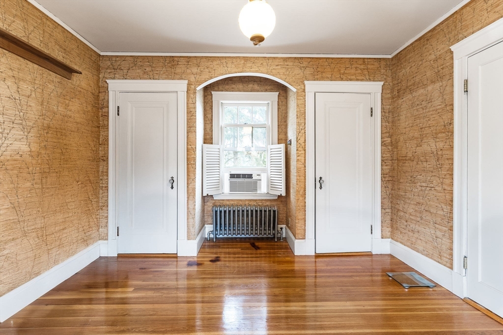 29 Undine Road Boston, MA 02135 - Photo 8 of 16 a view of empty room with wooden floor and fan