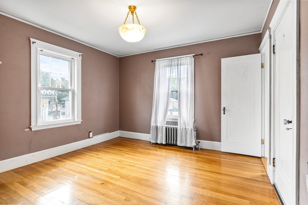 29 Undine Road Boston, MA 02135 - Photo 10 of 16 a view of empty room with wooden floor and fan