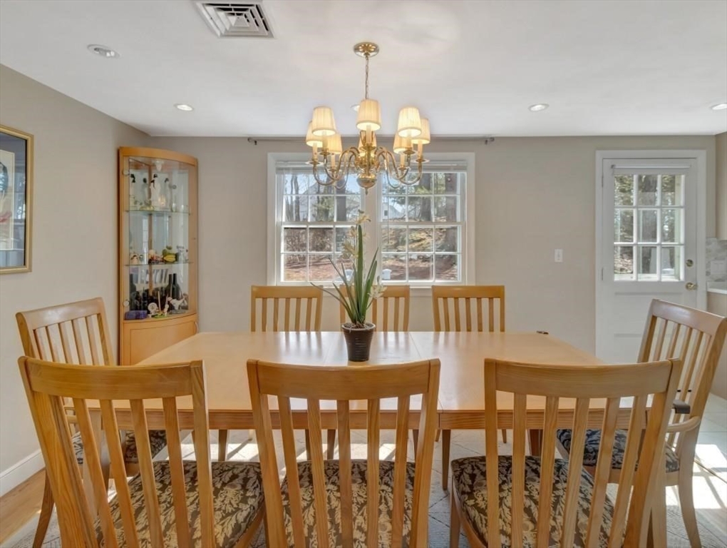 22 Susan Drive Saugus, MA 01906 - Photo 15 of 42 a view of a dining room with furniture a chandelier and wooden floor