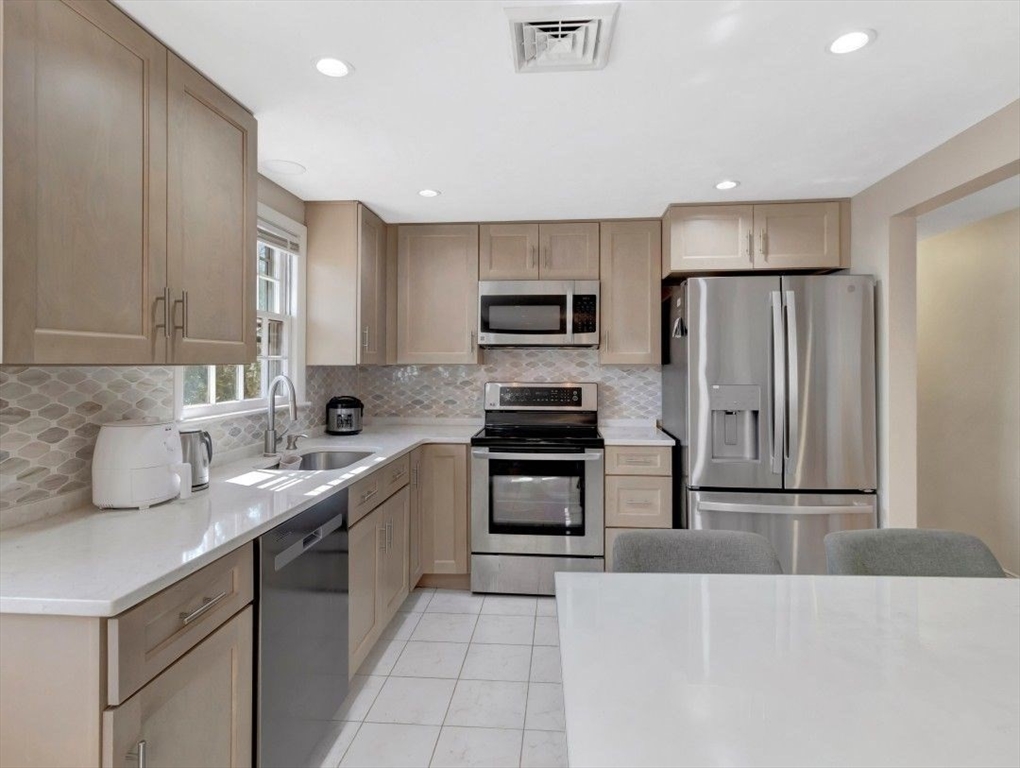 22 Susan Drive Saugus, MA 01906 - Photo 19 of 42 a kitchen with stainless steel appliances granite countertop a refrigerator sink and stove