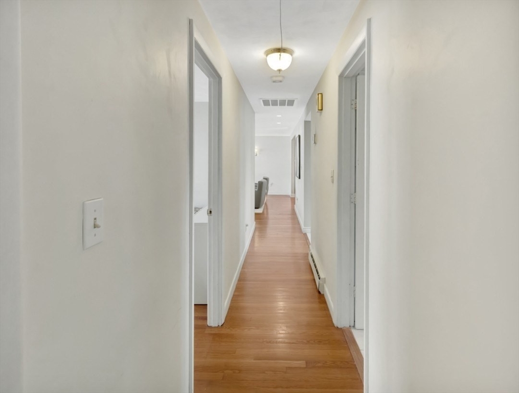 22 Susan Drive Saugus, MA 01906 - Photo 20 of 42 a view of a hallway with wooden floor