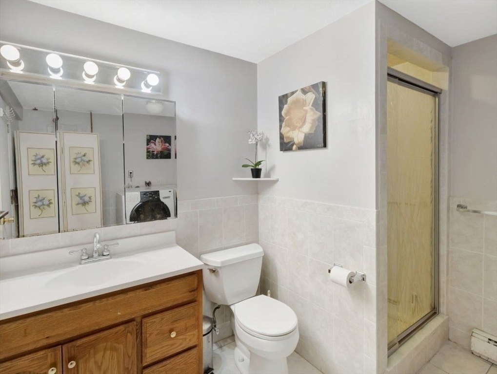 22 Susan Drive Saugus, MA 01906 - Photo 33 of 42 a bathroom with a toilet a sink and mirror