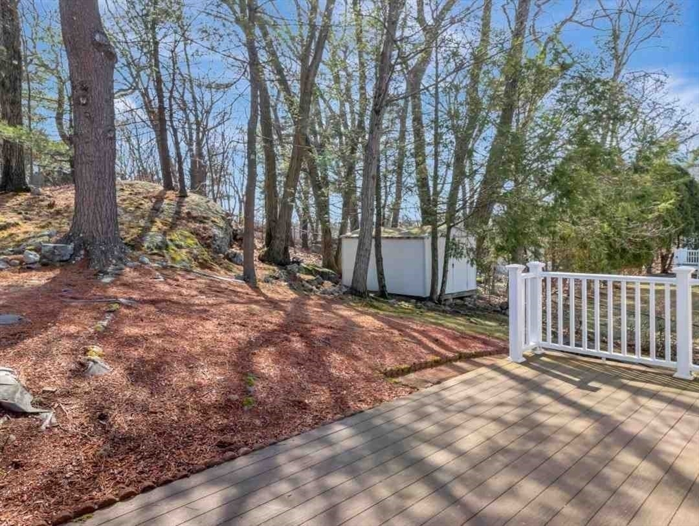 22 Susan Drive Saugus, MA 01906 - Photo 37 of 42 a view of a backyard with large trees and wooden fence