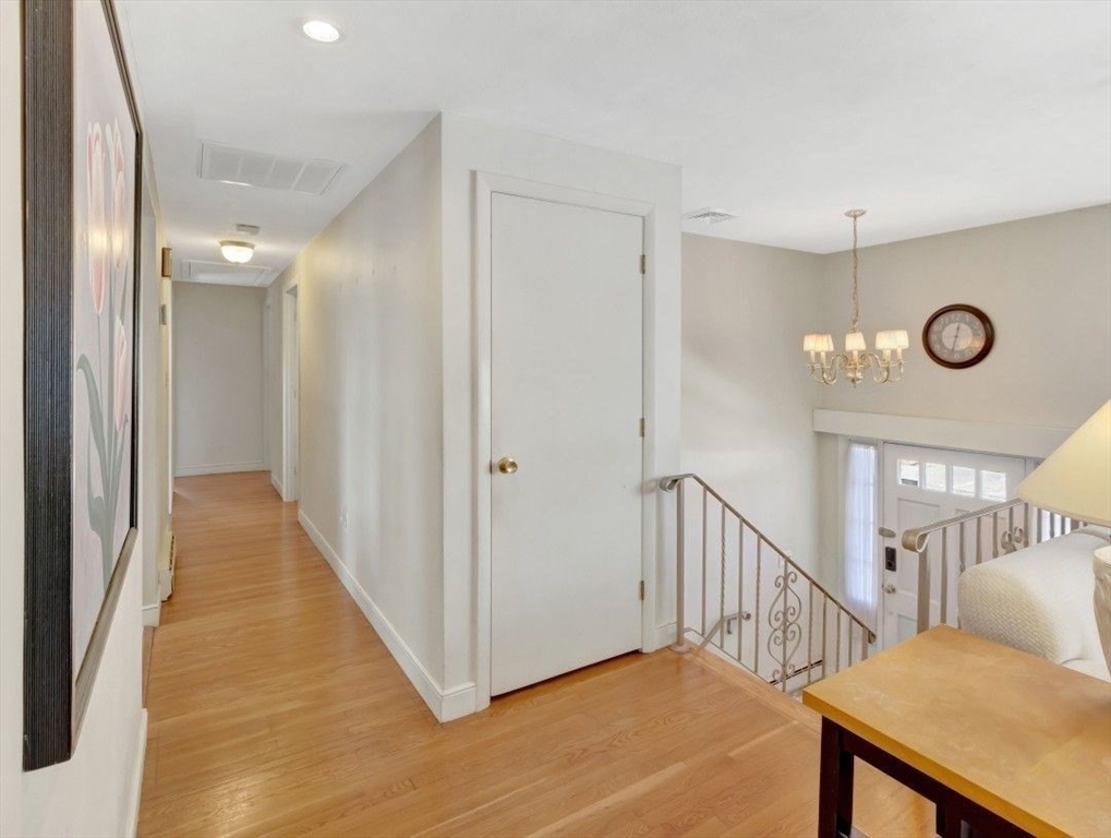 22 Susan Drive Saugus, MA 01906 - Photo 6 of 42 a view of a hallway with wooden floor and windows