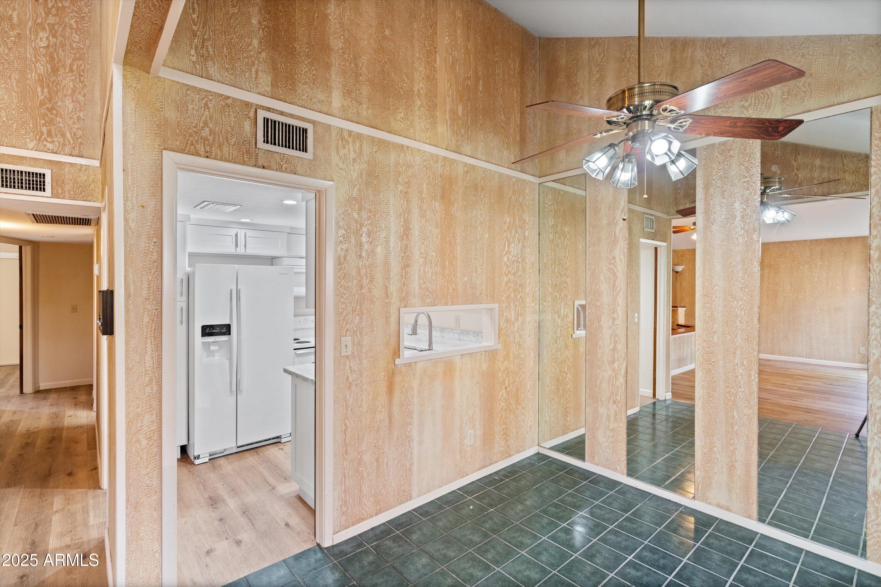 6533 North 7th Avenue, Unit 34 Phoenix, AZ 85013 - Photo 13 of 32 a view of a hallway with a chandelier fan and windows