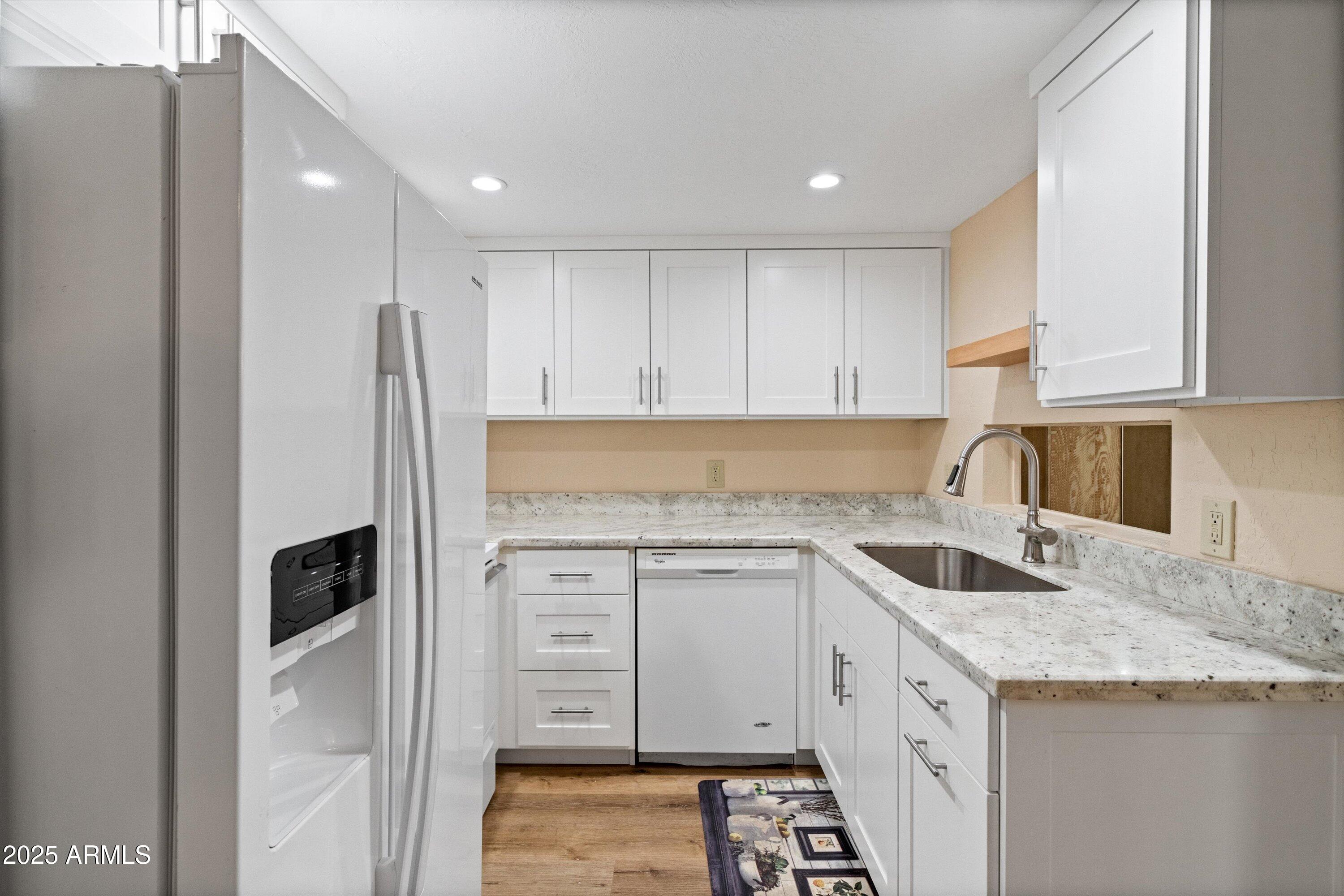 6533 North 7th Avenue, Unit 34 Phoenix, AZ 85013 - Photo 15 of 32 a kitchen with granite countertop a sink and a refrigerator