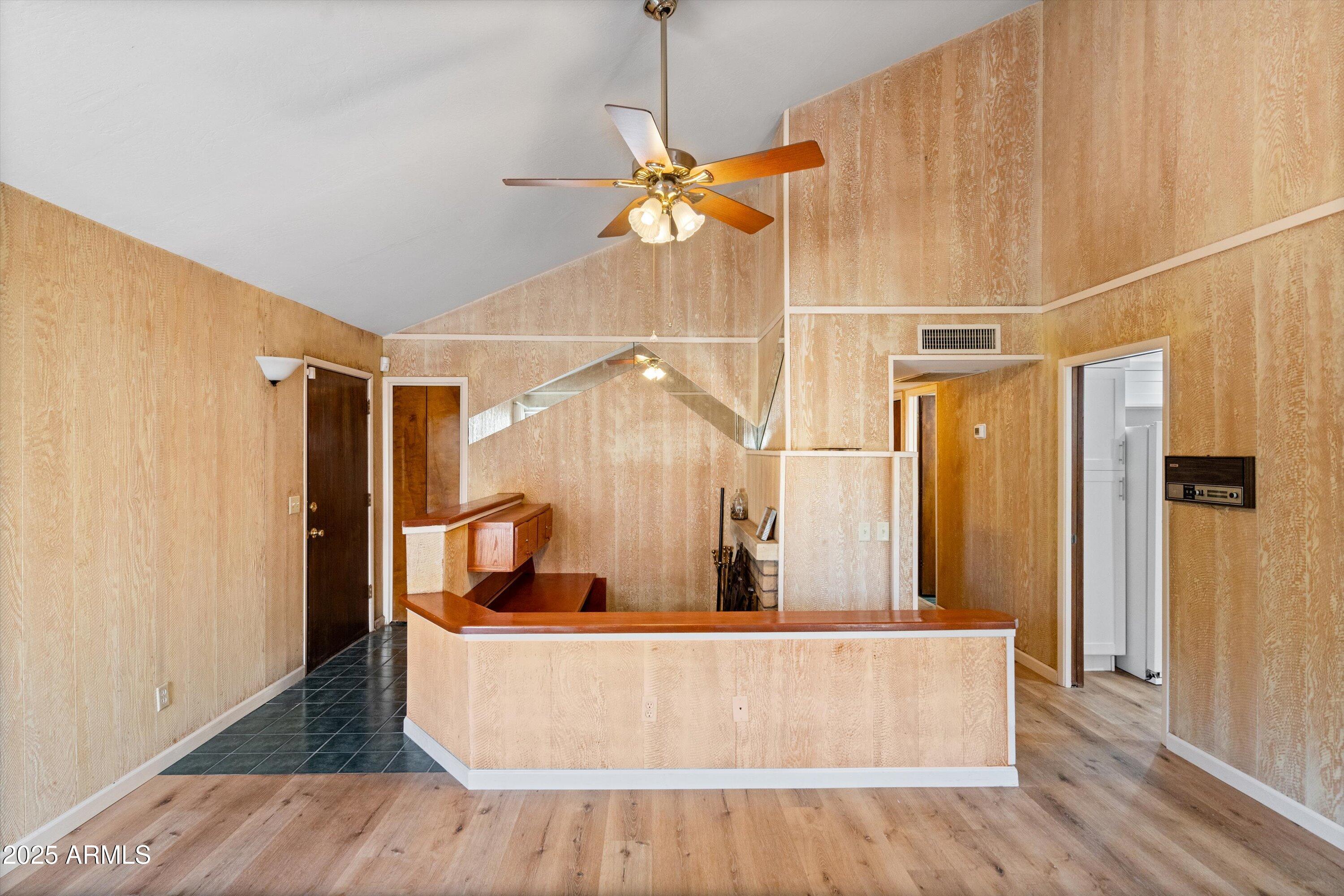 6533 North 7th Avenue, Unit 34 Phoenix, AZ 85013 - Photo 2 of 32 a living room with large mirror and a wooden floor