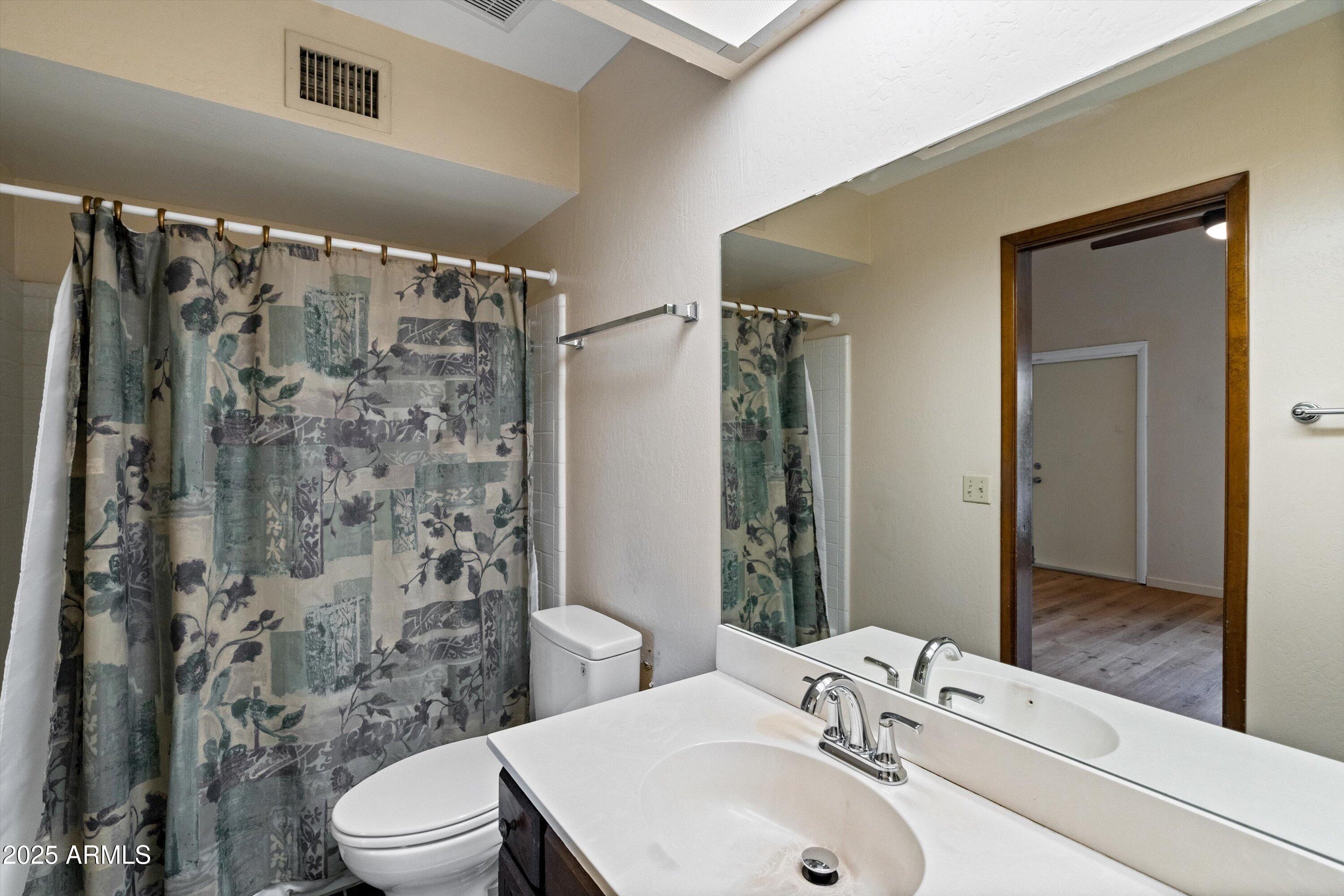 6533 North 7th Avenue, Unit 34 Phoenix, AZ 85013 - Photo 21 of 32 a bathroom with a sink a toilet and shower