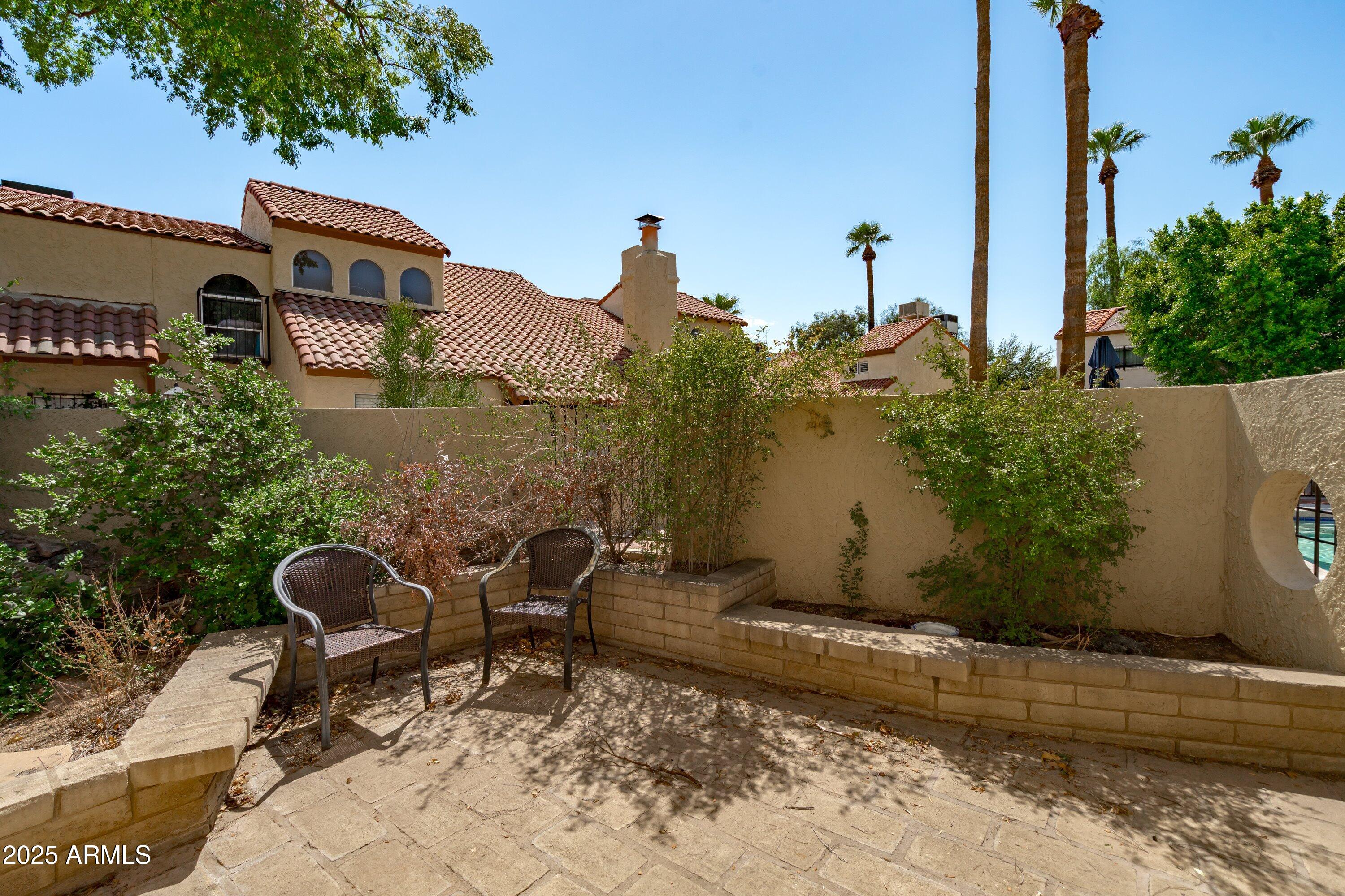6533 North 7th Avenue, Unit 34 Phoenix, AZ 85013 - Photo 28 of 32 a view of a chairs and table in the backyard