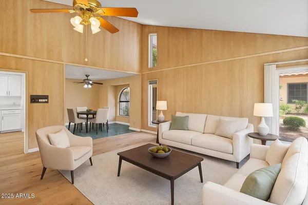 en empty room with wooden floor and fan