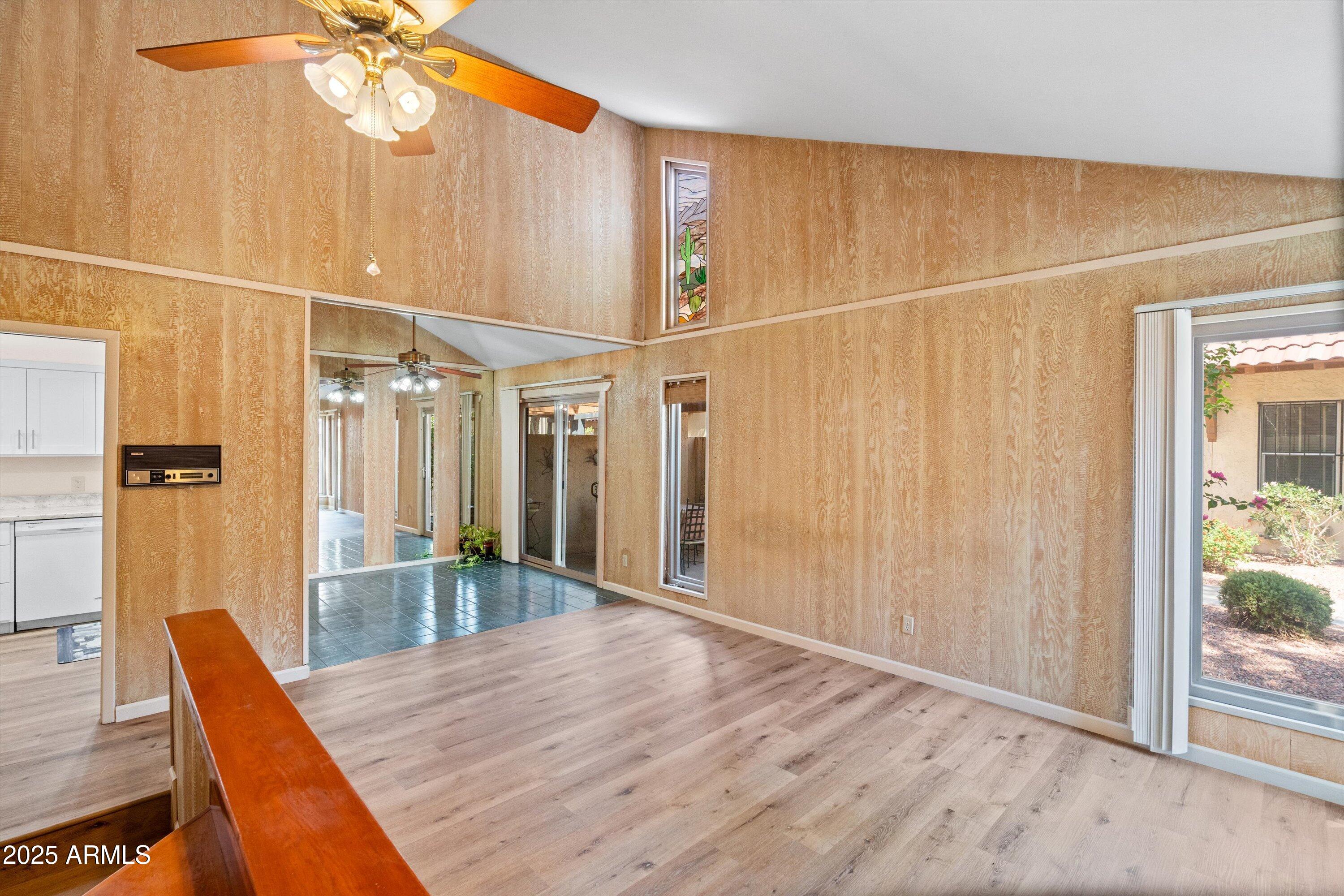 6533 North 7th Avenue, Unit 34 Phoenix, AZ 85013 - Photo 5 of 32 en empty room with wooden floor and fan