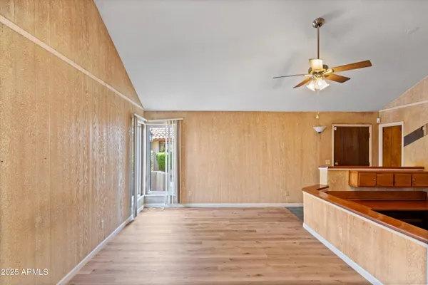 a view of a room with a ceiling fan