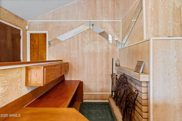 a view of a livingroom with wooden floor and staircase