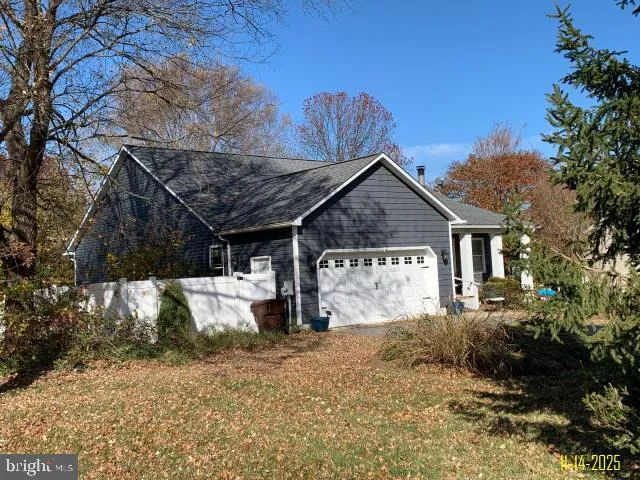 a view of a house with wooden fence