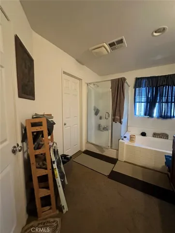 a bedroom with furniture and a flat screen tv