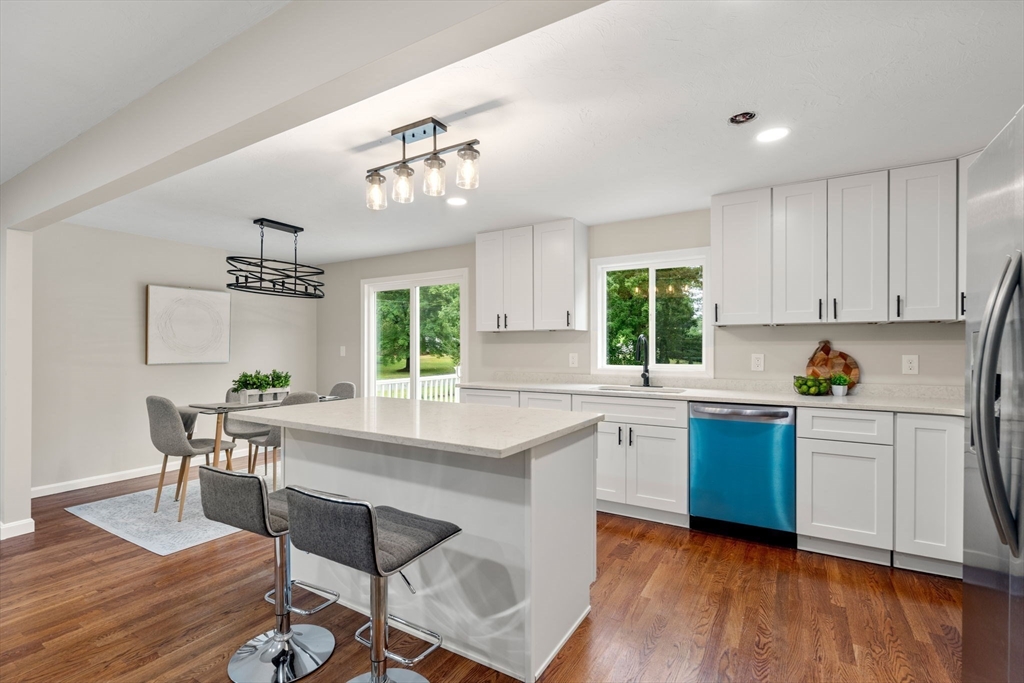 7 Prescott Road Sutton, MA 01588 - Photo 2 of 34 a kitchen with a table chairs stove and cabinets