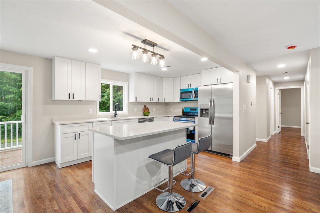 7 Prescott Road Sutton, MA 01588 - Photo 3 of 34 a kitchen with white cabinets and stainless steel appliances