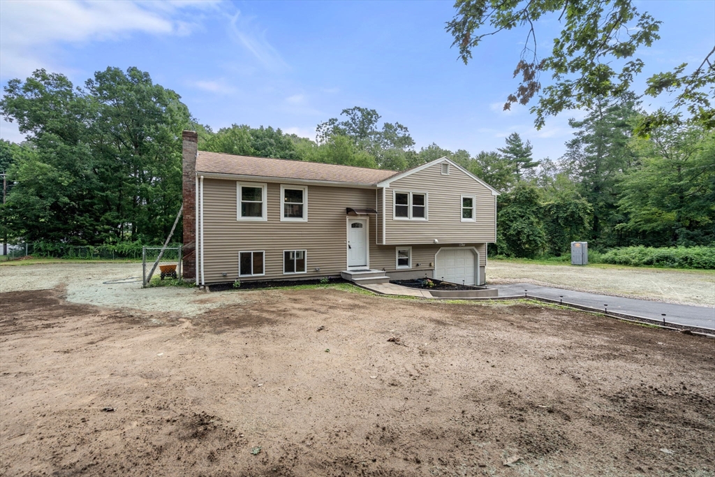 7 Prescott Road Sutton, MA 01588 - Photo 33 of 34 a front view of a house with a yard and garage