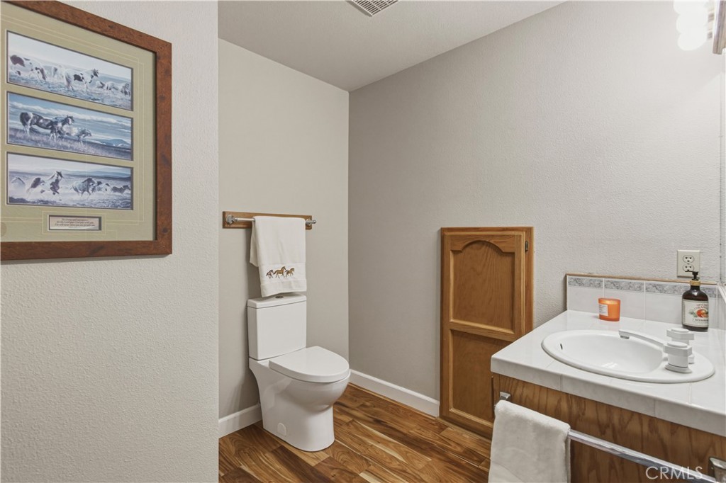 3856 North Gardner Avenue Merced, CA 95340 - Photo 30 of 59 a bathroom with a sink toilet and mirror