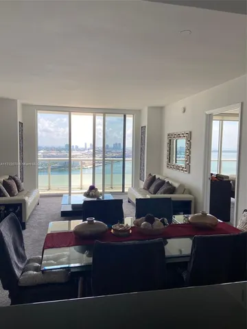 a living room with furniture and large windows