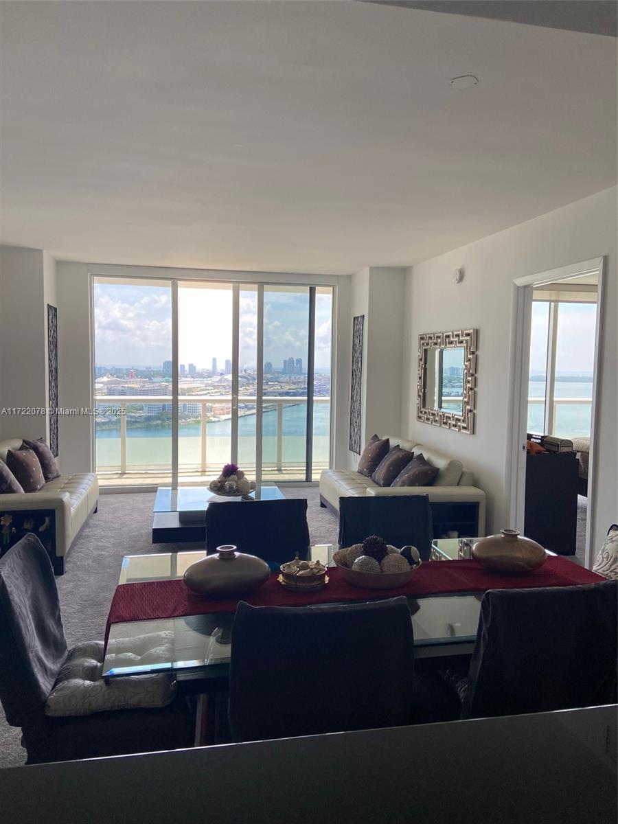 50 Biscayne Boulevard, Unit 2906 Miami, FL 33132 - Photo 3 of 4 a living room with furniture and large windows