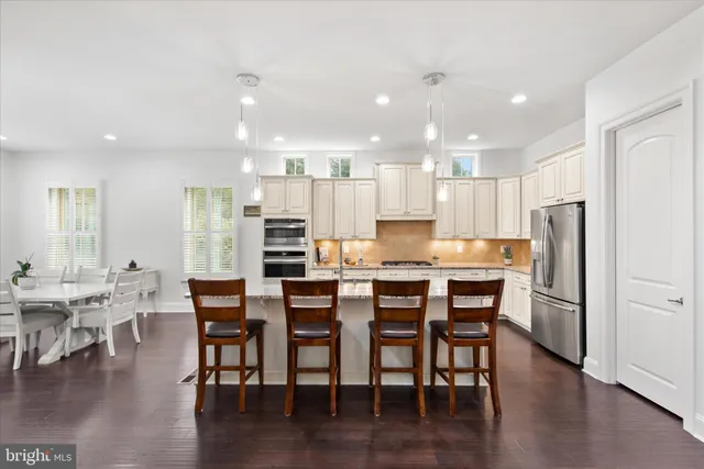 a view of living room with granite countertop furniture and wooden floor