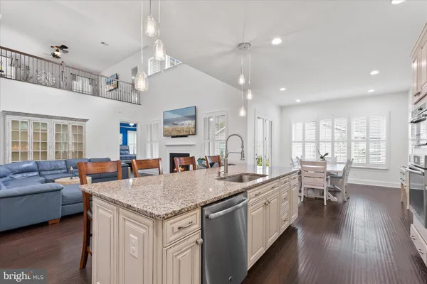 a kitchen with a dining table chairs and refrigerator