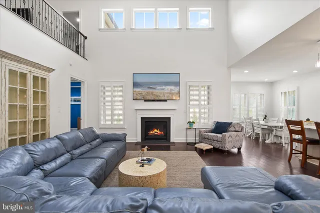 a living room with furniture large window and fireplace