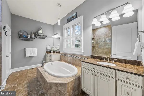 a bathroom with a granite countertop sink mirror toilet and shower