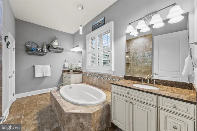 a bathroom with a granite countertop sink mirror toilet and shower
