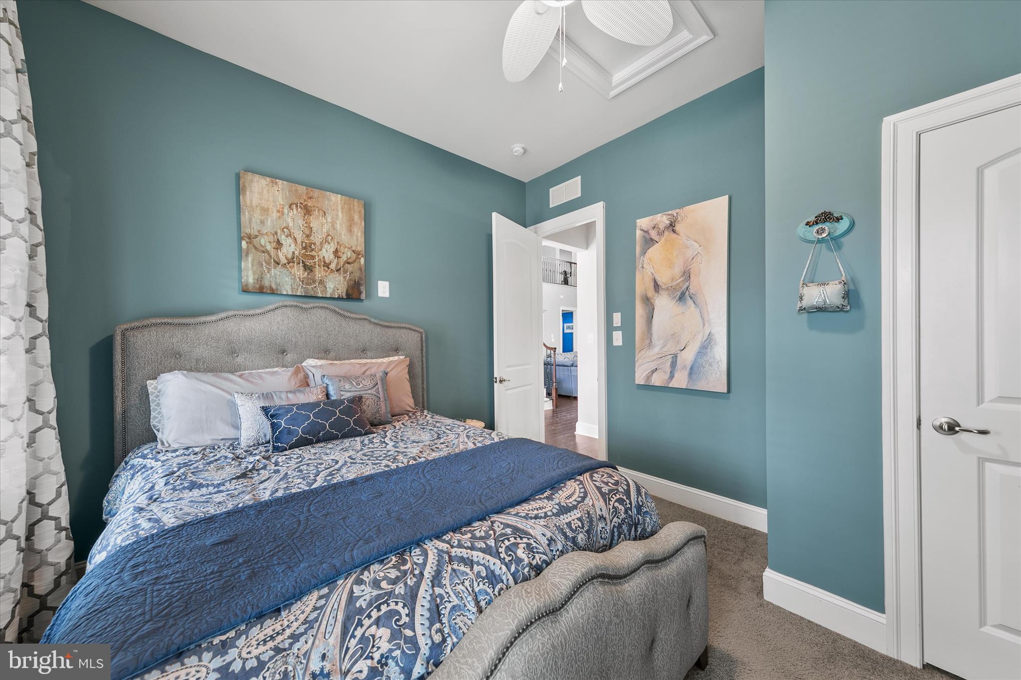 34749 Timber Court Dagsboro, DE 19939 - Photo 26 of 60 a bedroom with a large bed and a chandelier