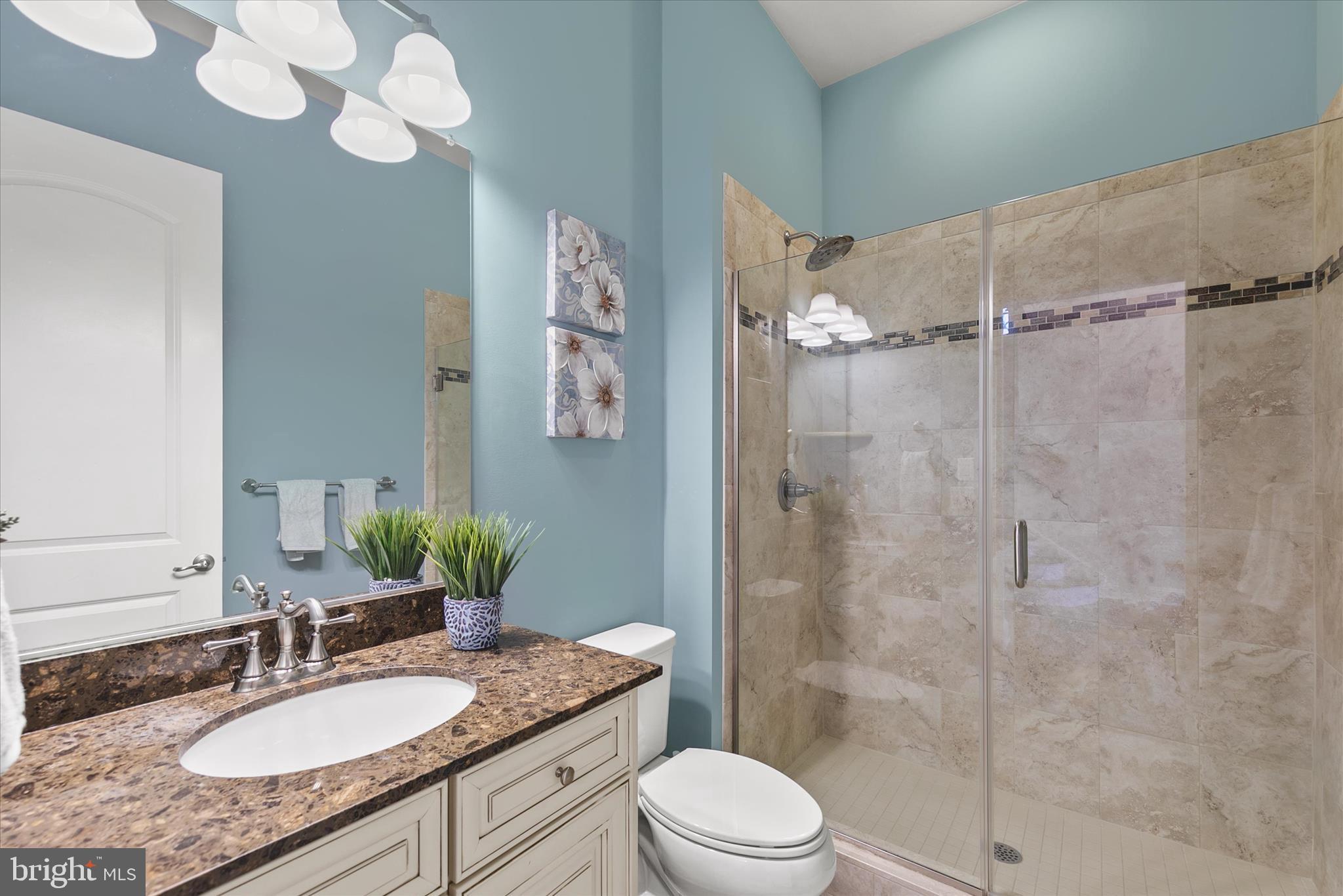 34749 Timber Court Dagsboro, DE 19939 - Photo 28 of 60 a bathroom with a granite countertop sink mirror toilet and shower