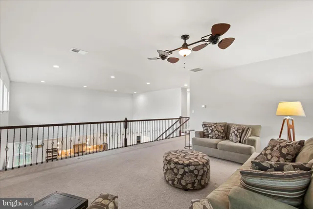 a bedroom with a bed and a ceiling fan