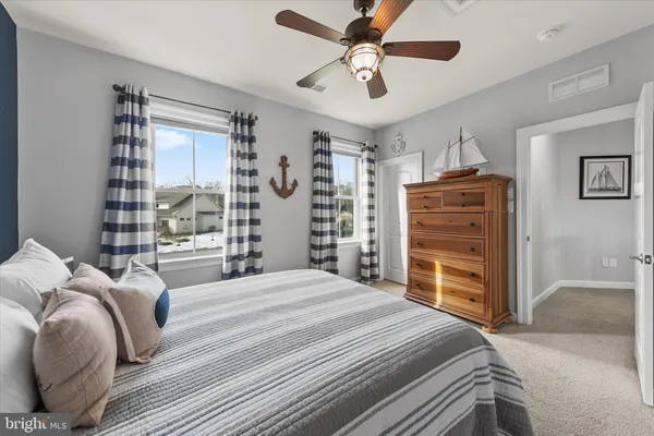 a spacious bathroom with a granite countertop double vanity sink a mirror and a toilet